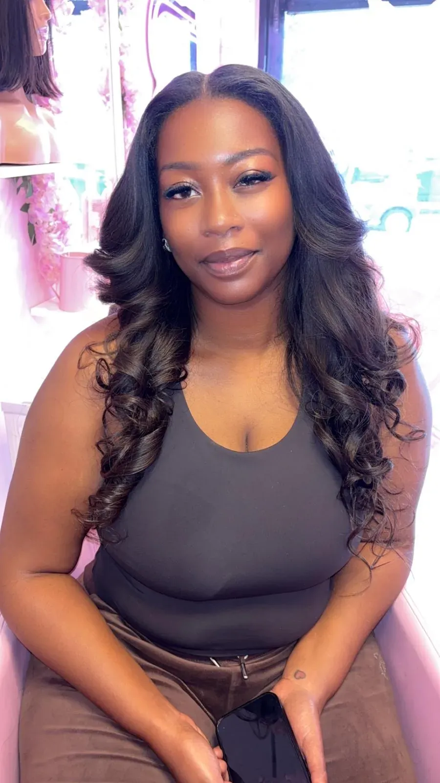 Long, glossy body waves styled at SYM’S